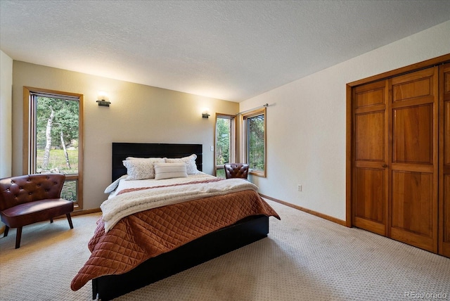 26452 Wolverine Trl, Evergreen, CO 80439 - bedroom featuring light colored carpet, multiple windows, baseboards, and a textured ceiling