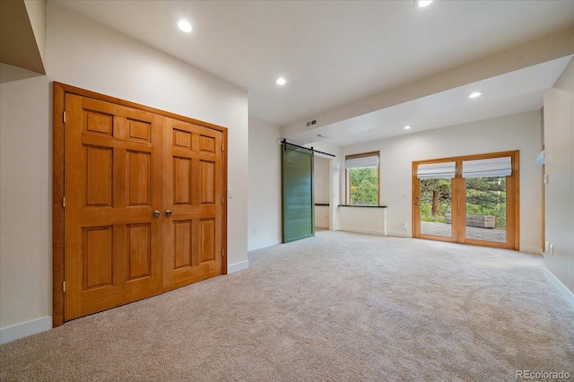 26452 Wolverine Trl, Evergreen, CO 80439 - empty room with a barn door, carpet floors, recessed lighting, and baseboards