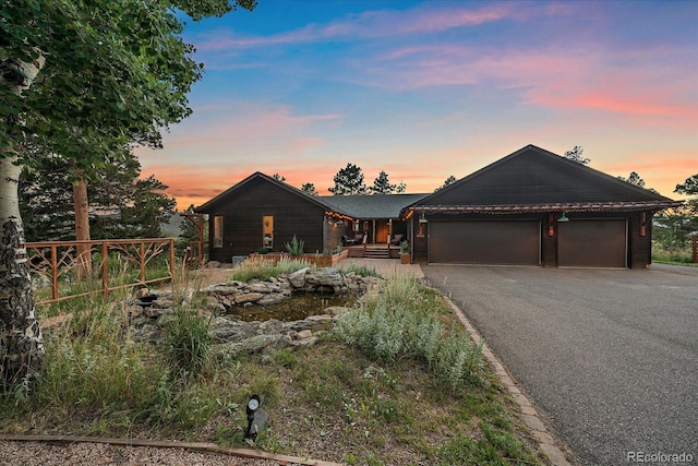 26452 Wolverine Trl, Evergreen, CO 80439 - view of front facade featuring an attached garage and driveway