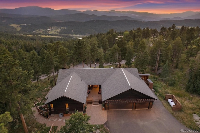 26452 Wolverine Trl, Evergreen, CO 80439 - aerial view at dusk of a wooded view and a mountain view