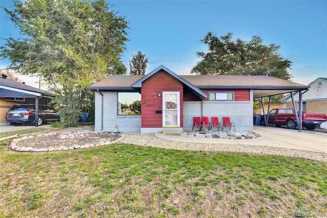 view of front of property with a front lawn and a carport