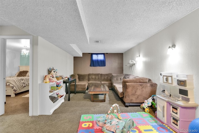 living room with carpet floors, a textured ceiling, and visible vents