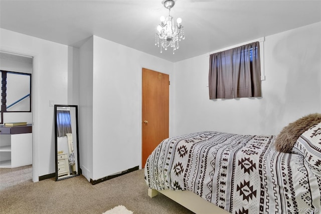 bedroom with carpet flooring and an inviting chandelier