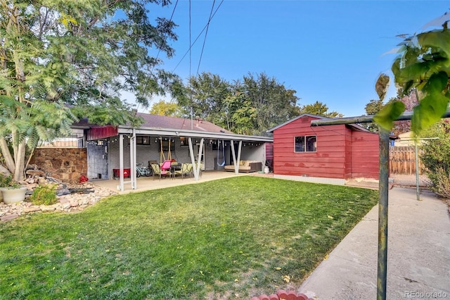 rear view of property with fence, a yard, and a patio area