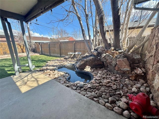 view of yard featuring a patio and a fenced backyard