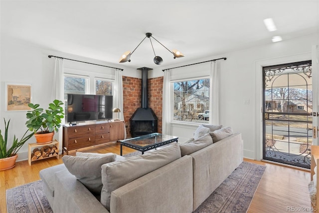 living room featuring a wood stove and wood finished floors