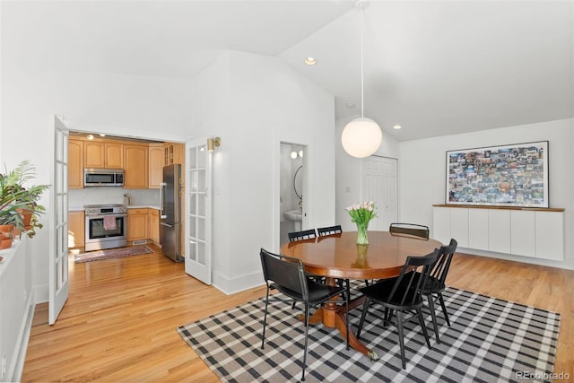 dining area featuring recessed lighting, baseboards, vaulted ceiling, and light wood finished floors