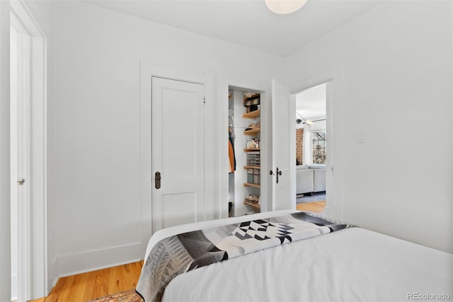 bedroom with a closet and light wood finished floors