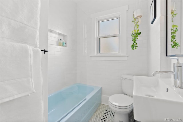 bathroom featuring bathtub / shower combination, tile walls, toilet, and tile patterned floors