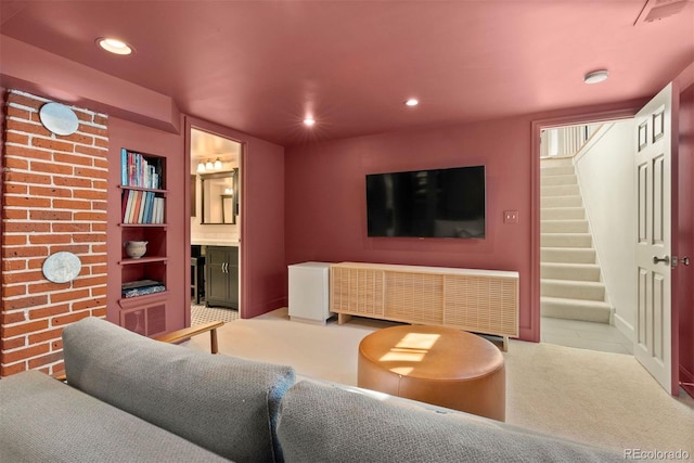 carpeted living area with recessed lighting, visible vents, and stairway