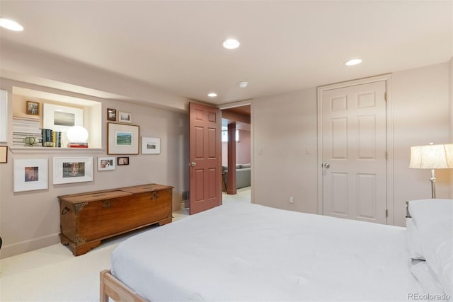 carpeted bedroom featuring baseboards and recessed lighting