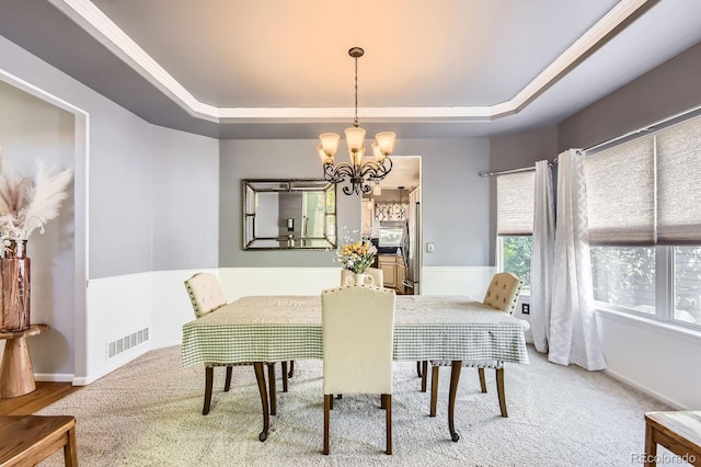 10330 Lions Path, Lone Tree, CO 80124 - dining area with a tray ceiling, a chandelier, light carpet, and baseboards