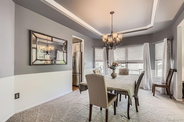 10330 Lions Path, Lone Tree, CO 80124 - dining room with a chandelier, light carpet, a tray ceiling, and baseboards