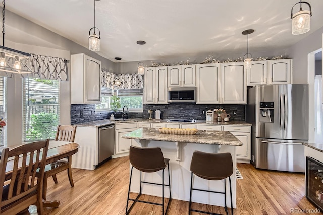 10330 Lions Path, Lone Tree, CO 80124 - kitchen with stainless steel appliances, light stone countertops, a sink, and tasteful backsplash