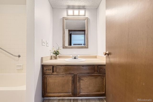 7665 E Eastman Ave Unit 111A, Denver, CO 80231 - full bathroom featuring a textured ceiling and vanity