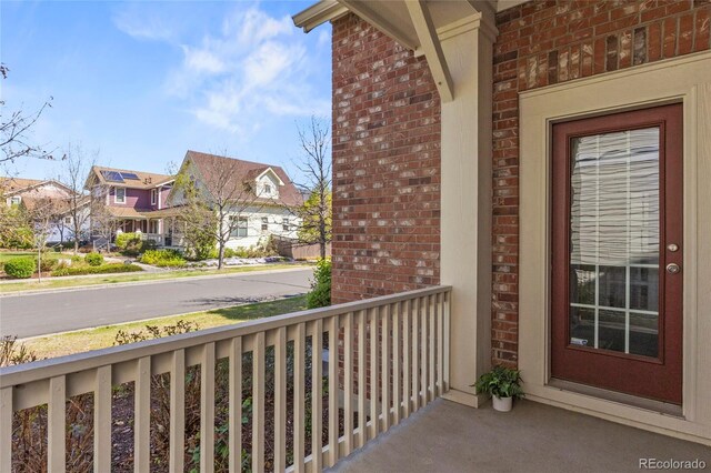 balcony with covered porch and a residential view