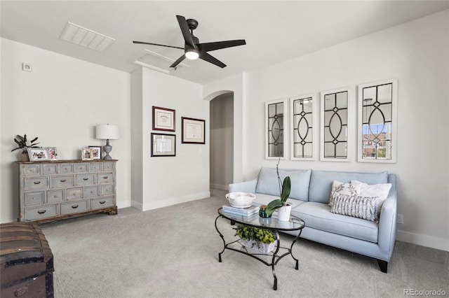 carpeted living room featuring ceiling fan, arched walkways, baseboards, and visible vents