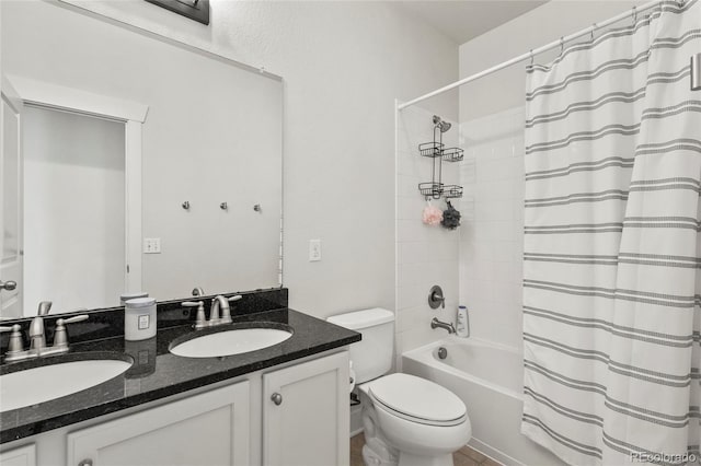 bathroom featuring double vanity, toilet, shower / bath combination with curtain, and a sink