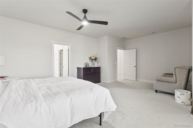 carpeted bedroom featuring baseboards and a ceiling fan