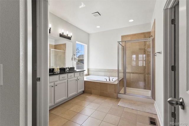 bathroom with tile patterned floors, a bath, visible vents, a shower stall, and vanity