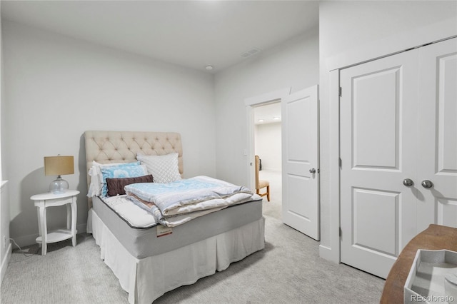 bedroom with light colored carpet and visible vents