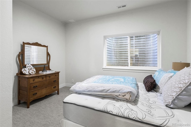 bedroom featuring carpet flooring and visible vents