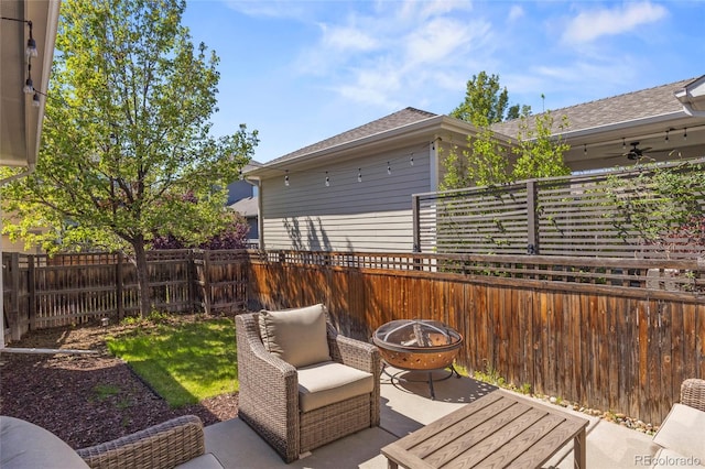 view of patio / terrace featuring a fenced backyard and a fire pit