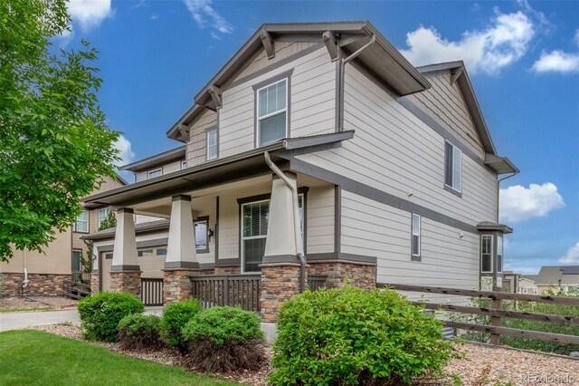 676 Fossil Bed Cir, Erie, CO 80516 - view of property exterior featuring a porch and stone siding
