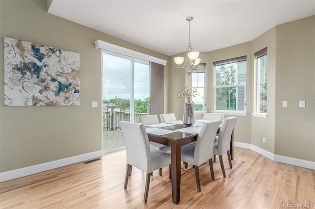 676 Fossil Bed Cir, Erie, CO 80516 - dining space with a chandelier, light wood-style floors, and baseboards