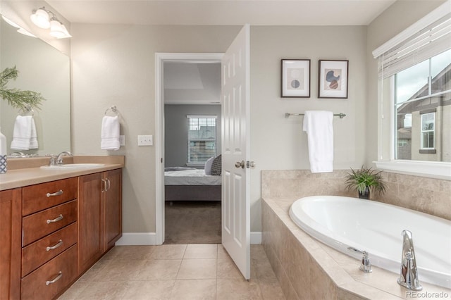 676 Fossil Bed Cir, Erie, CO 80516 - full bathroom with a garden tub, vanity, ensuite bathroom, tile patterned flooring, and baseboards