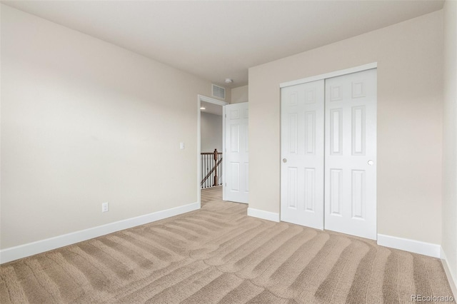 676 Fossil Bed Cir, Erie, CO 80516 - unfurnished bedroom with light colored carpet, baseboards, and a closet