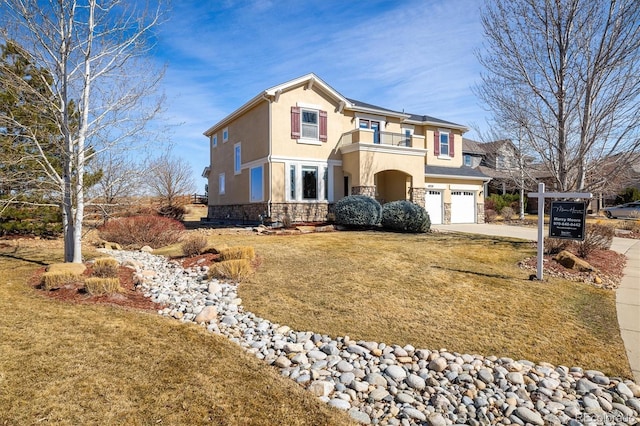 view of front facade featuring stucco siding, concrete driveway, a balcony, a garage, and stone siding