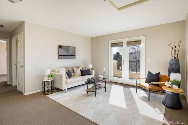 living area featuring french doors, carpet, and baseboards