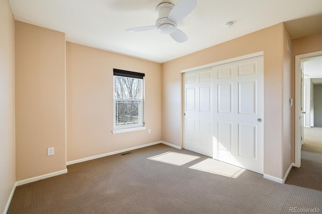 unfurnished bedroom with carpet floors, a closet, and baseboards