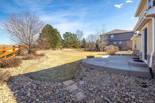 view of yard with fence and a patio