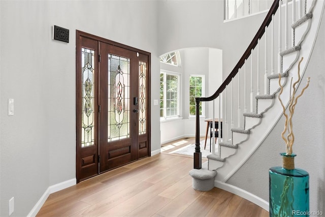 1473 E 130th Dr, Thornton, CO 80241 - entrance foyer featuring wood finished floors, stairway, and a high ceiling