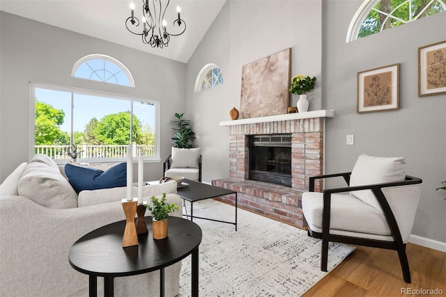 1473 E 130th Dr, Thornton, CO 80241 - living room with high vaulted ceiling, wood finished floors, a fireplace, and a chandelier