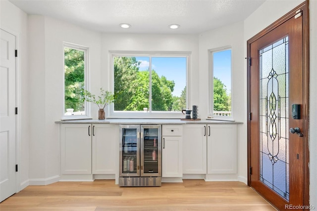 1473 E 130th Dr, Thornton, CO 80241 - indoor bar featuring wine cooler, light wood-style floors, recessed lighting, and plenty of natural light