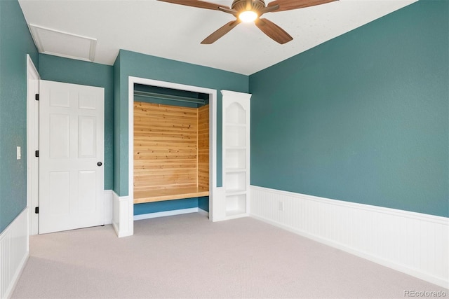 1473 E 130th Dr, Thornton, CO 80241 - unfurnished bedroom with carpet flooring, wainscoting, ceiling fan, attic access, and a closet