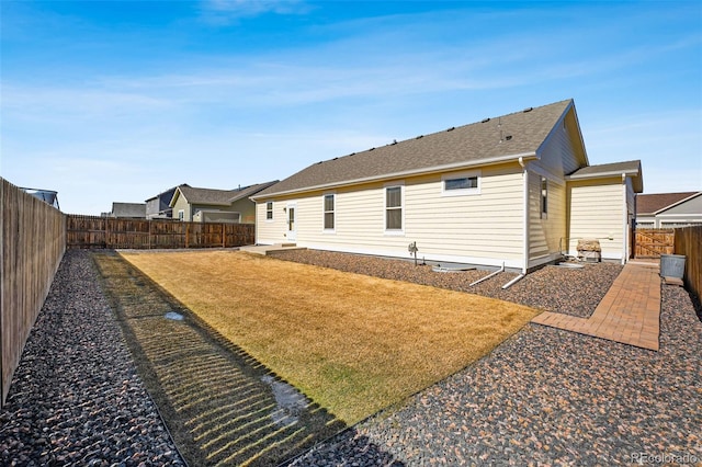 rear view of house with a yard, a patio area, and a fenced backyard