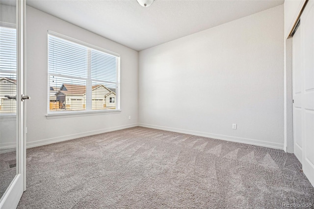 unfurnished bedroom with carpet, baseboards, and a closet