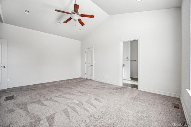 carpeted spare room with high vaulted ceiling, baseboards, visible vents, and a ceiling fan