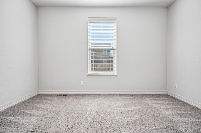 carpeted empty room with baseboards