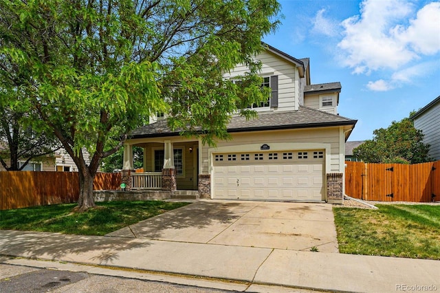 1248 Button Rock Dr, Longmont, CO 80504 - view of front of house featuring covered porch, driveway, a garage, brick siding, and a gate