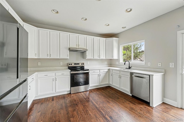 1248 Button Rock Dr, Longmont, CO 80504 - kitchen with appliances with stainless steel finishes, under cabinet range hood, a sink, dark wood-style flooring, and white cabinets