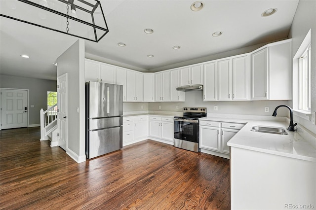 1248 Button Rock Dr, Longmont, CO 80504 - kitchen featuring appliances with stainless steel finishes, a sink, under cabinet range hood, healthy amount of natural light, and recessed lighting