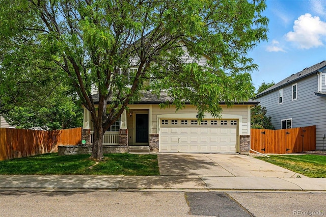 1248 Button Rock Dr, Longmont, CO 80504 - obstructed view of property featuring brick siding, driveway, a gate, and a garage