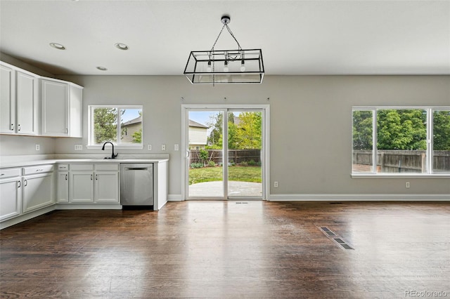 1248 Button Rock Dr, Longmont, CO 80504 - kitchen featuring stainless steel dishwasher, dark wood-type flooring, light countertops, white cabinets, and recessed lighting