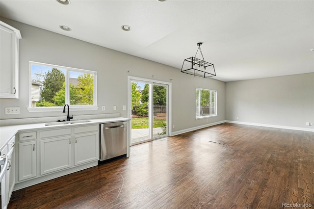 1248 Button Rock Dr, Longmont, CO 80504 - kitchen featuring dishwasher, a sink, open floor plan, dark wood-style floors, and light countertops
