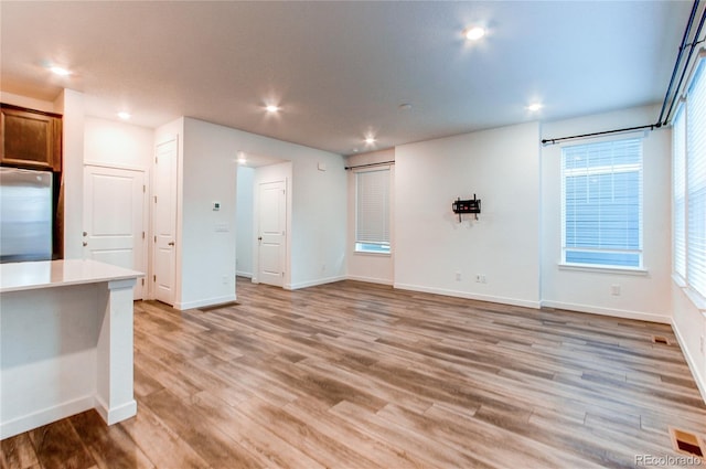 unfurnished living room with plenty of natural light and light wood-type flooring